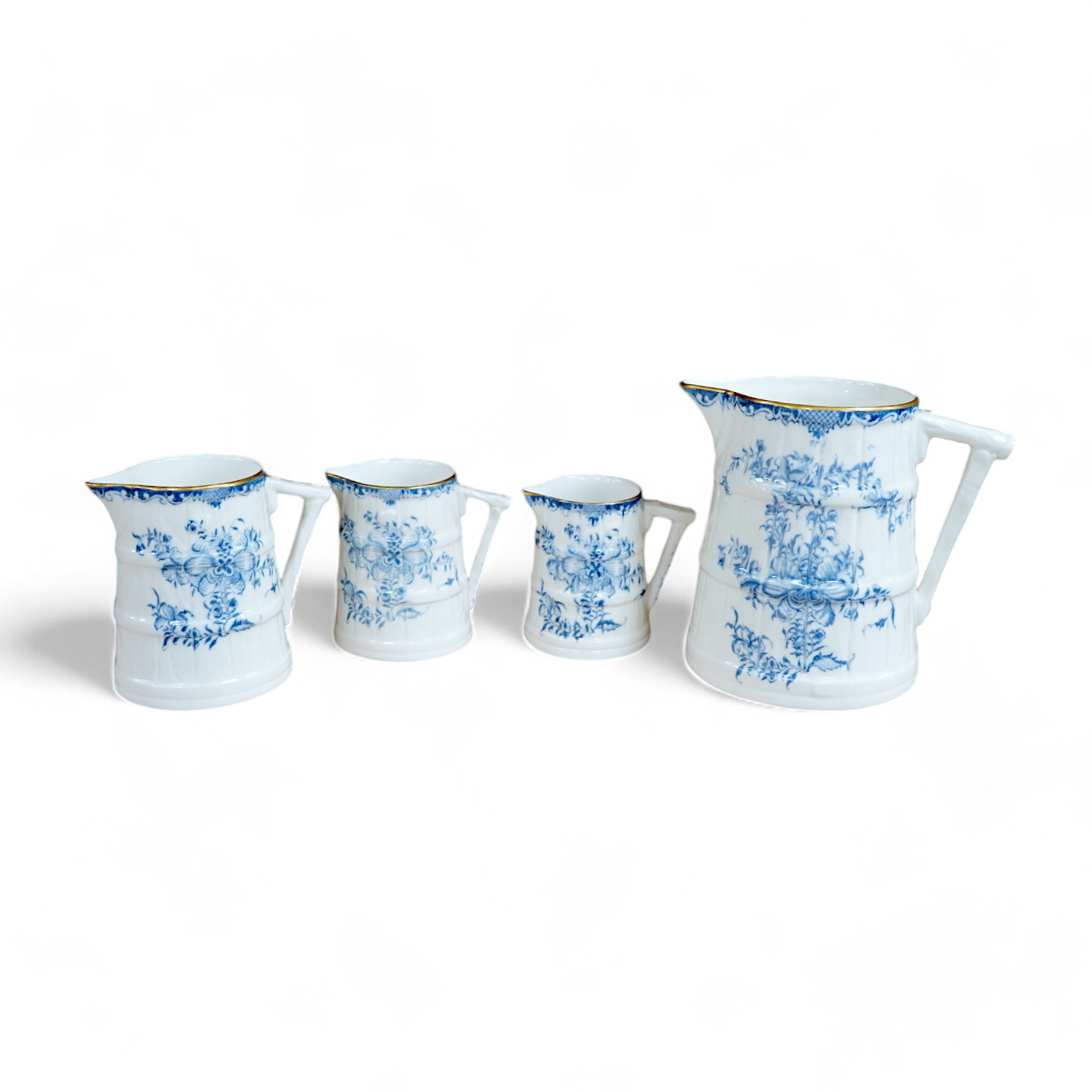 A graduated set of four Royal Worcester blue and white jugs, tallest 11cm. Condition - good.